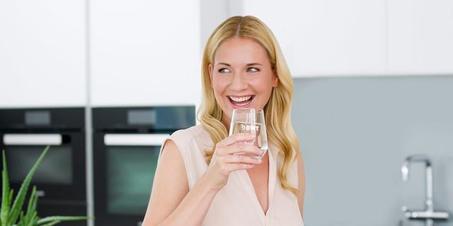 Woman enjoying a glass of mineralized water