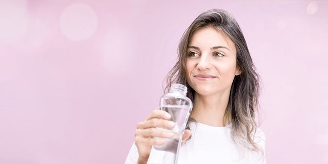 Woman holding a bottle of mineralized water