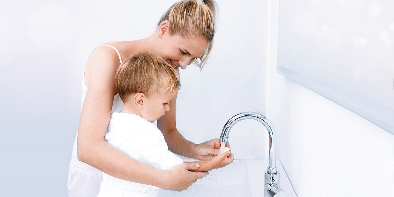 Mother and son washing hands