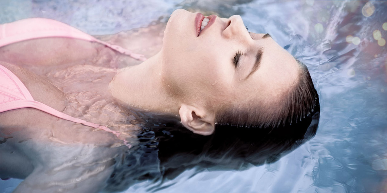 Woman relaxing in a swimming pool