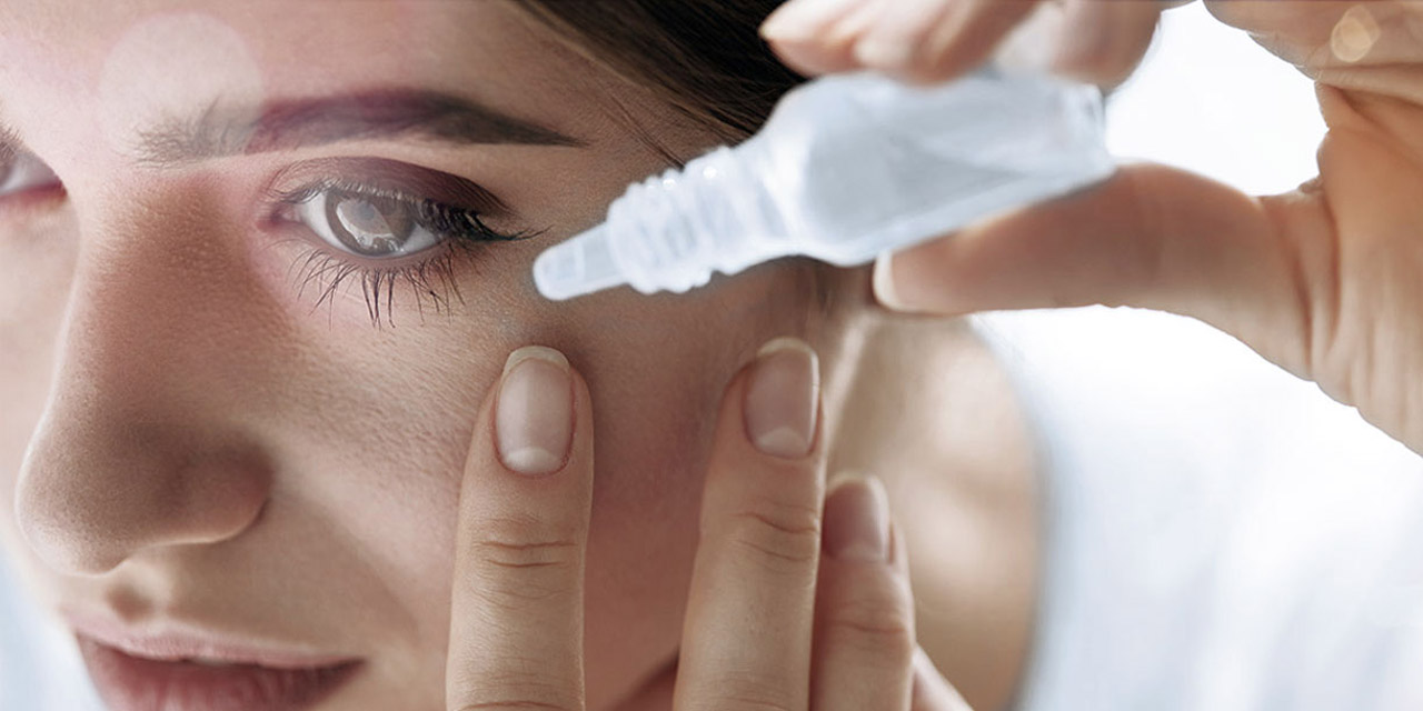 Woman using eyedrops