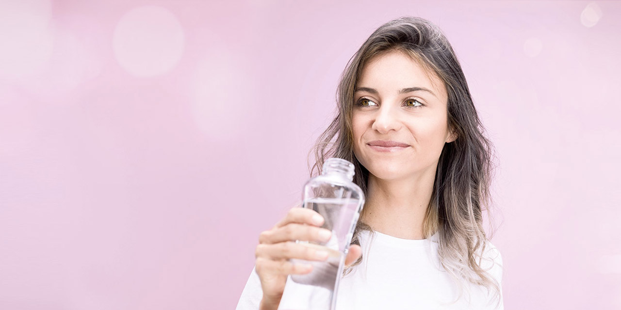 Woman holding a bottle of mineralized water